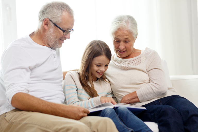 Grandparents and granddaughter reading