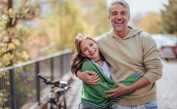 Father and daughter side hug